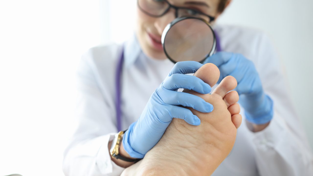 Podiatrist examining a patient's toe for an ingrown toenail